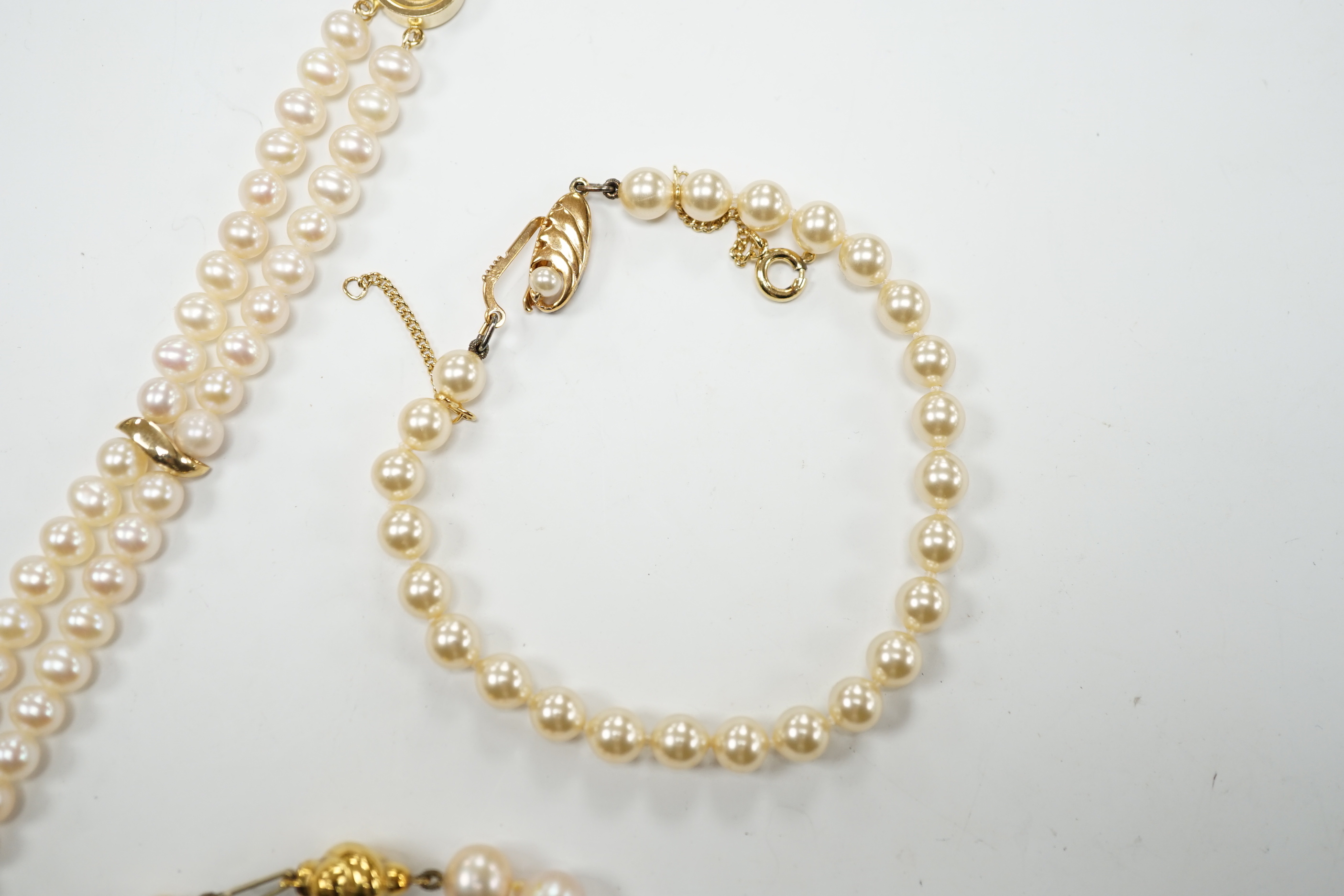 A modern double strand cultured pearl bracelet, with 14k clasp, 18cm, one other cultured pearl bracelet with 375 clasp and a simulated pearl bracelet.